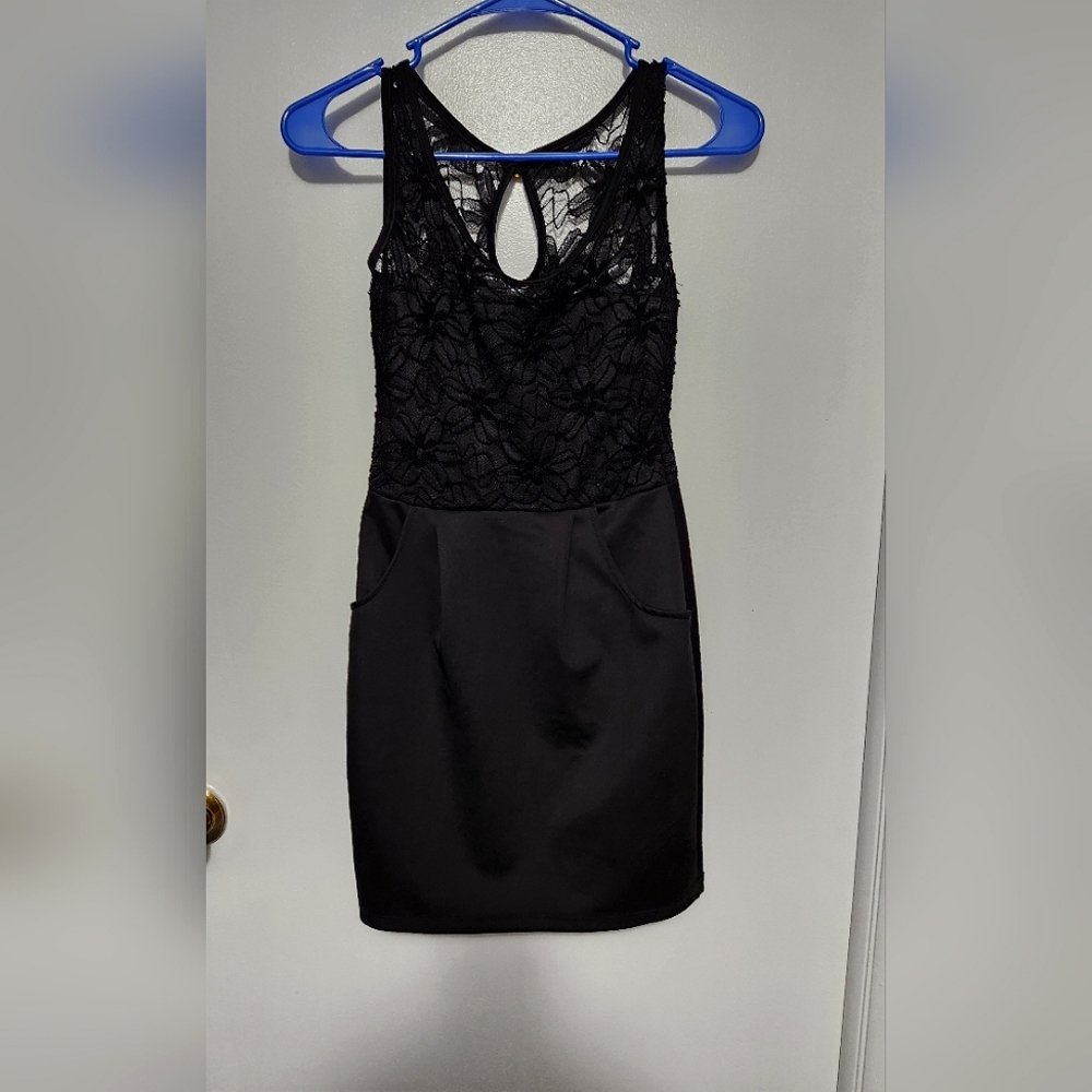 Black, small, thigh-high dress, silk skirt with pockets and lace top.